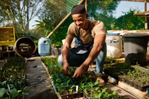 Young Black Farmer with plants